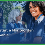 A smiling woman with curly hair wearing a blue lanyard is surrounded by diverse volunteers outdoors. Text overlay reads, “How to start a nonprofit in Pennsylvania.”