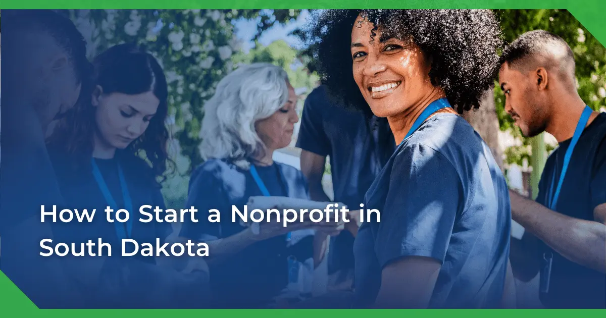 A smiling woman with curly hair wearing a blue lanyard is surrounded by diverse volunteers outdoors. Text overlay reads, “How to start a nonprofit in South Dakota.”