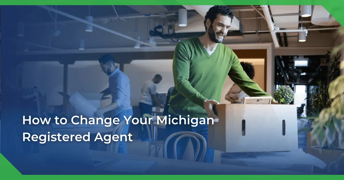Man in a green sweater smiling and carrying a box in an office setting. Others are packing or working. Text reads Michigan change of registered agent for a nonprofit.