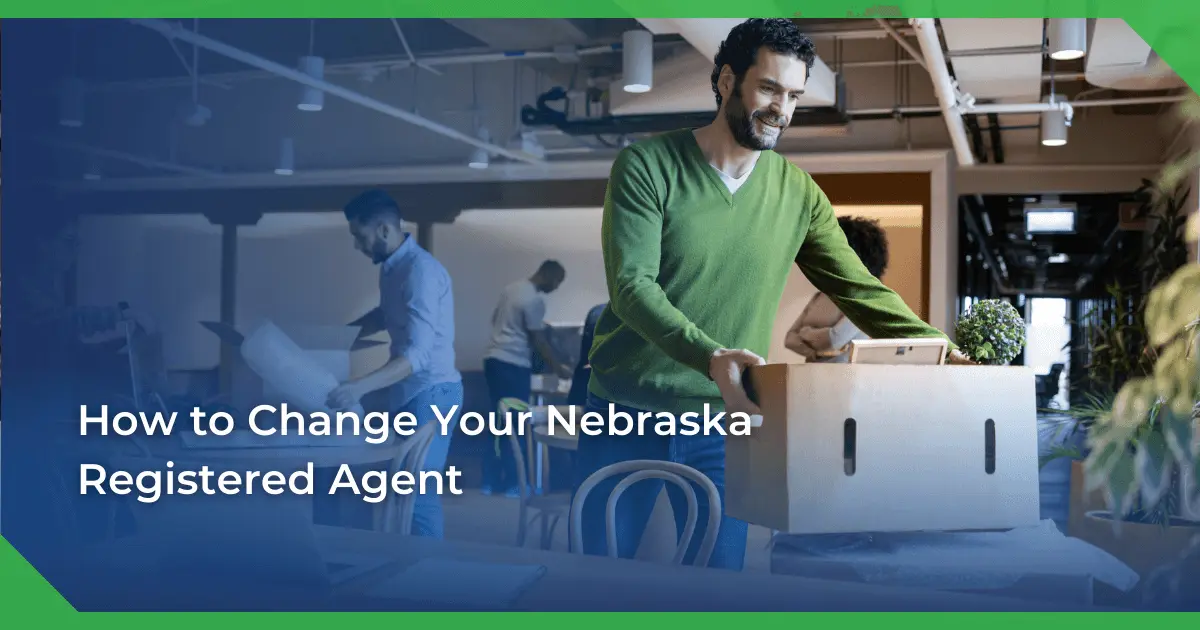 Man in a green sweater smiling and carrying a box in an office setting. Others are packing or working. Text reads Nebraska change of registered agent for a nonprofit.