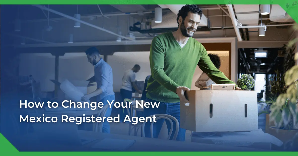 Man in a green sweater smiling and carrying a box in an office setting. Others are packing or working. Text reads New Mexico change of registered agent for a nonprofit.
