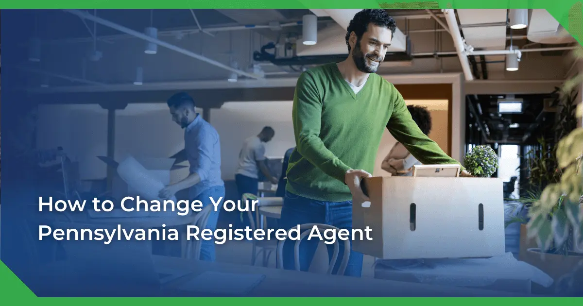 Man in a green sweater smiling and carrying a box in an office setting. Others are packing or working. Text reads Pennsylvania change of registered agent for a nonprofit.