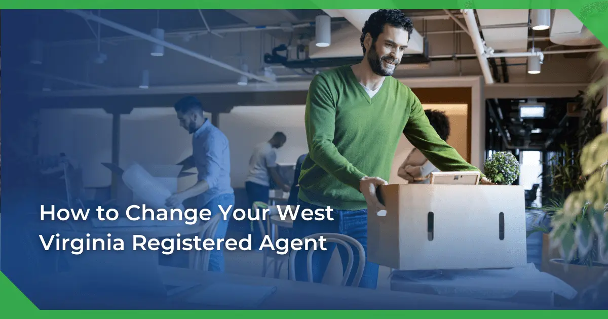 Man in a green sweater smiling and carrying a box in an office setting. Others are packing or working. Text reads West Virginia change of registered agent for a nonprofit.